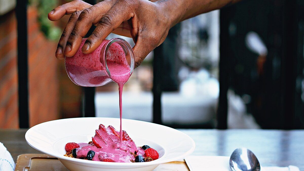 A bowl of fruit and yoghurt being served